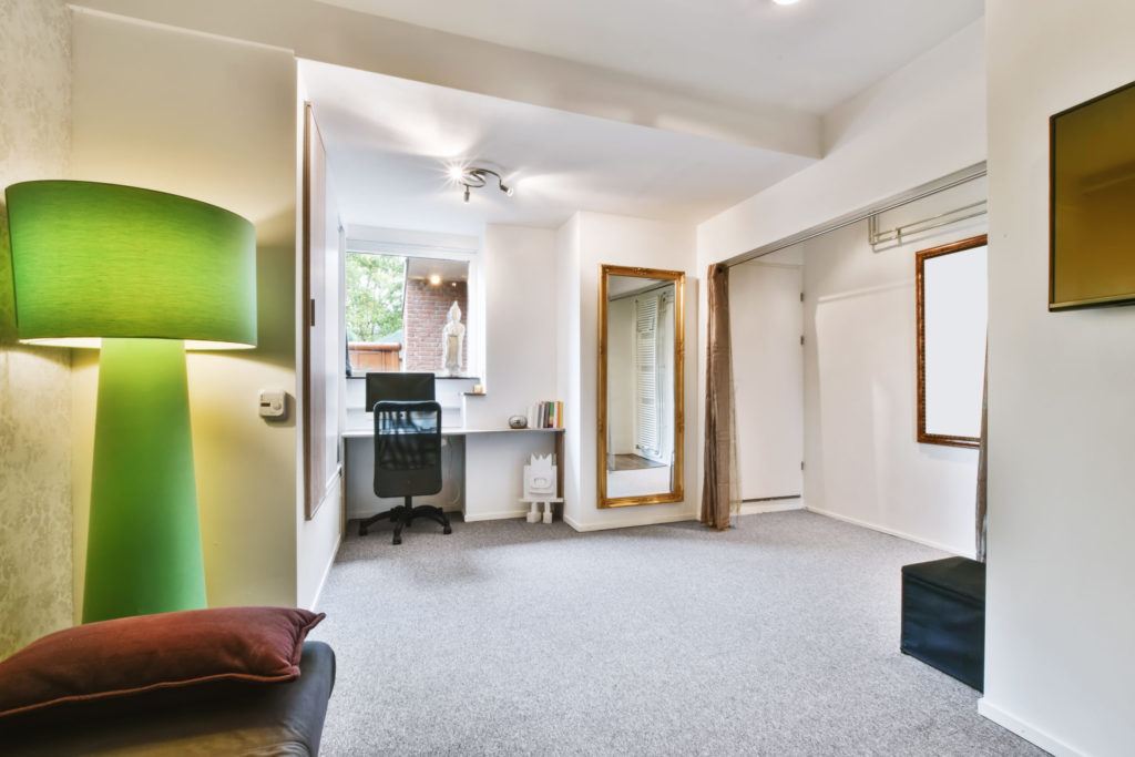 A cozy room with a green lamp