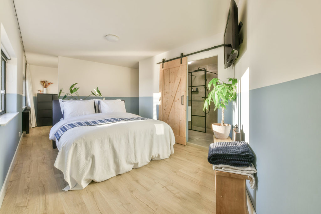 Bed with colorful pillows near window